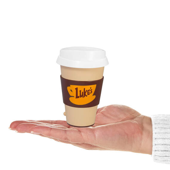 Luke's Diner Travel Mug Ornament with hand holding it