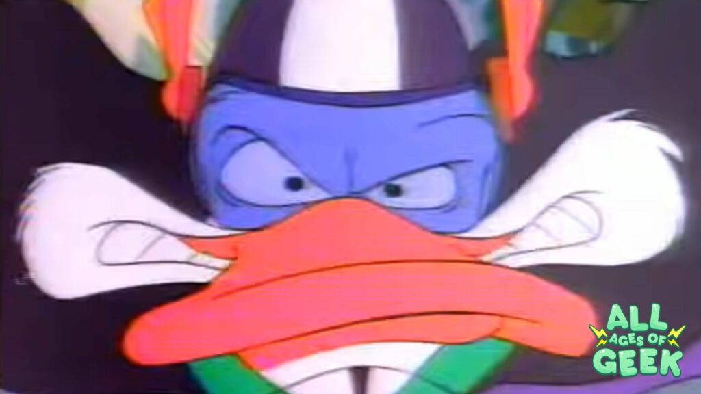 Darkwing Duck close up with an angry face used as a thumbnail for All Ages of Geek's article 90s Darkwing Duck is Still the Coolest Crusader in the Night