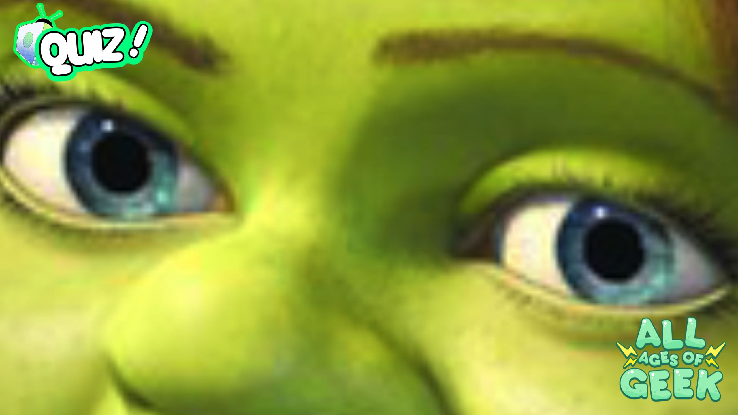 "A detailed close-up image of Fiona's eyes from the Shrek movie, showing her green skin and blue eyes. This image is featured on All Ages of Geek and includes their logo in the bottom right corner."