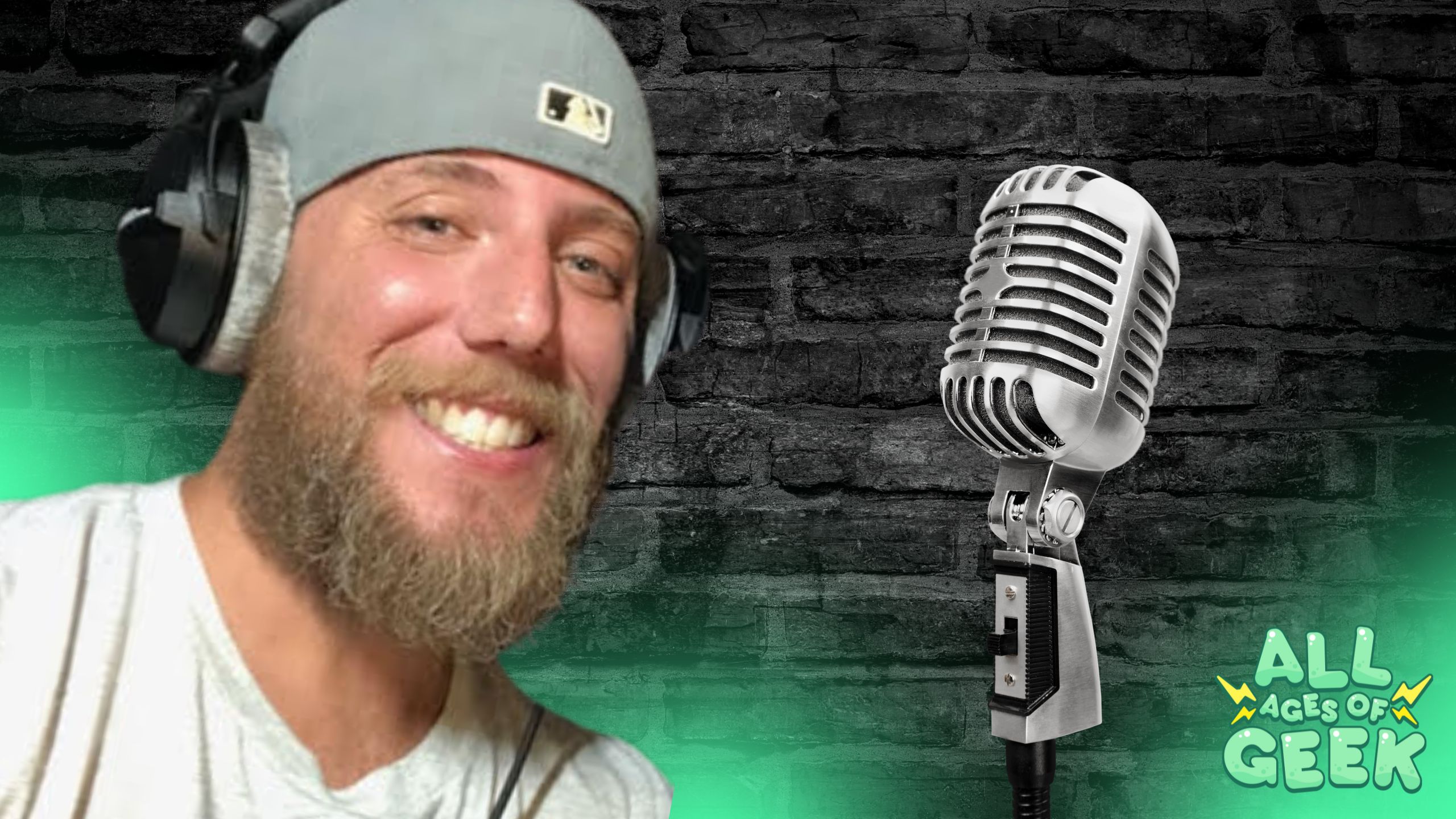 image of andy mack smiling next to a mic on a brick background all ages of geek logo on bottom right