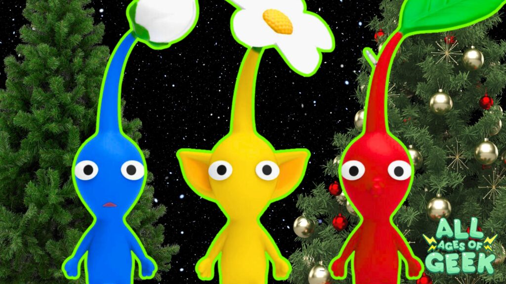 Three Pikmin ornaments, one blue, one yellow, and one red, are displayed in front of a background featuring two Christmas trees. The Pikmin characters have a bright green outline that makes them stand out against the dark, starry sky. The "All Ages of Geek" logo is visible in the bottom right corner, adding a festive touch to the scene.