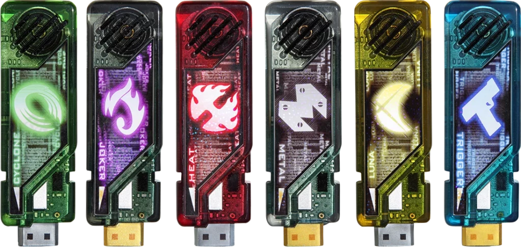 An image of six Gaia Memories from the Kamen Rider W series, each representing a different element or power. These USB-like devices are brightly colored and feature unique symbols that glow, indicating their respective abilities. From left to right, the colors and symbols are as follows: green with a cyclone symbol, purple with a flame-like Joker symbol, red with a fire symbol, silver with a metal symbol, yellow with a crescent moon symbol, and blue with a gun symbol. These Gaia Memories are key items used by Kamen Rider W to access various forms and powers during battle.