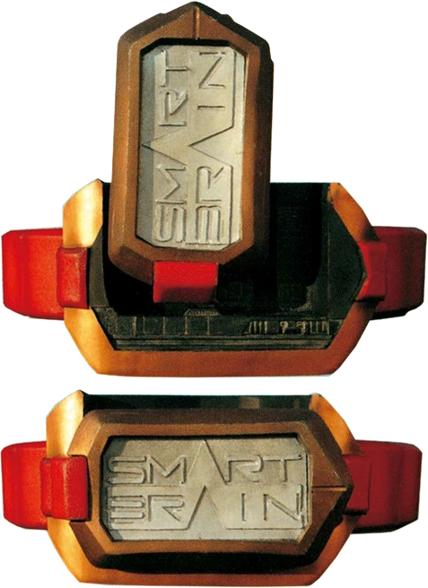 An image of the Smart Buckle from the Kamen Rider 555 (Faiz) series. The buckle has a rectangular design with a metallic appearance, featuring the words "SMART BRAIN" prominently engraved on its front. The device is encased in a bronze-colored frame and attached to a red belt. The buckle is a key component in the transformation system used by Kamen Rider Faiz, linking to the "Smart Brain" corporation, a central element in the series' storyline. The design is both sleek and industrial, reflecting the advanced technology and themes of the show.