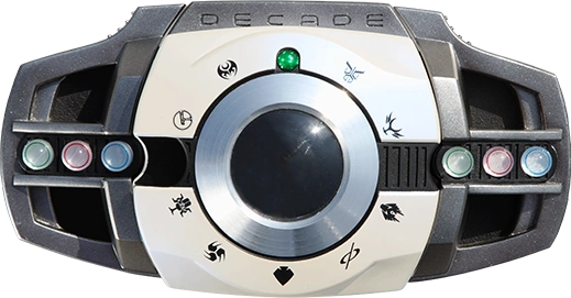 An image of the Kamen Rider DecaDriver belt, a sleek, modern-looking transformation device used by Kamen Rider Decade. The belt features a central circular lens surrounded by a silver frame with various symbols representing different Kamen Riders. The belt is predominantly black with colored buttons on either side, including green, red, and blue accents. The word "DECADE" is engraved on the top of the belt, indicating its connection to the Kamen Rider Decade series.