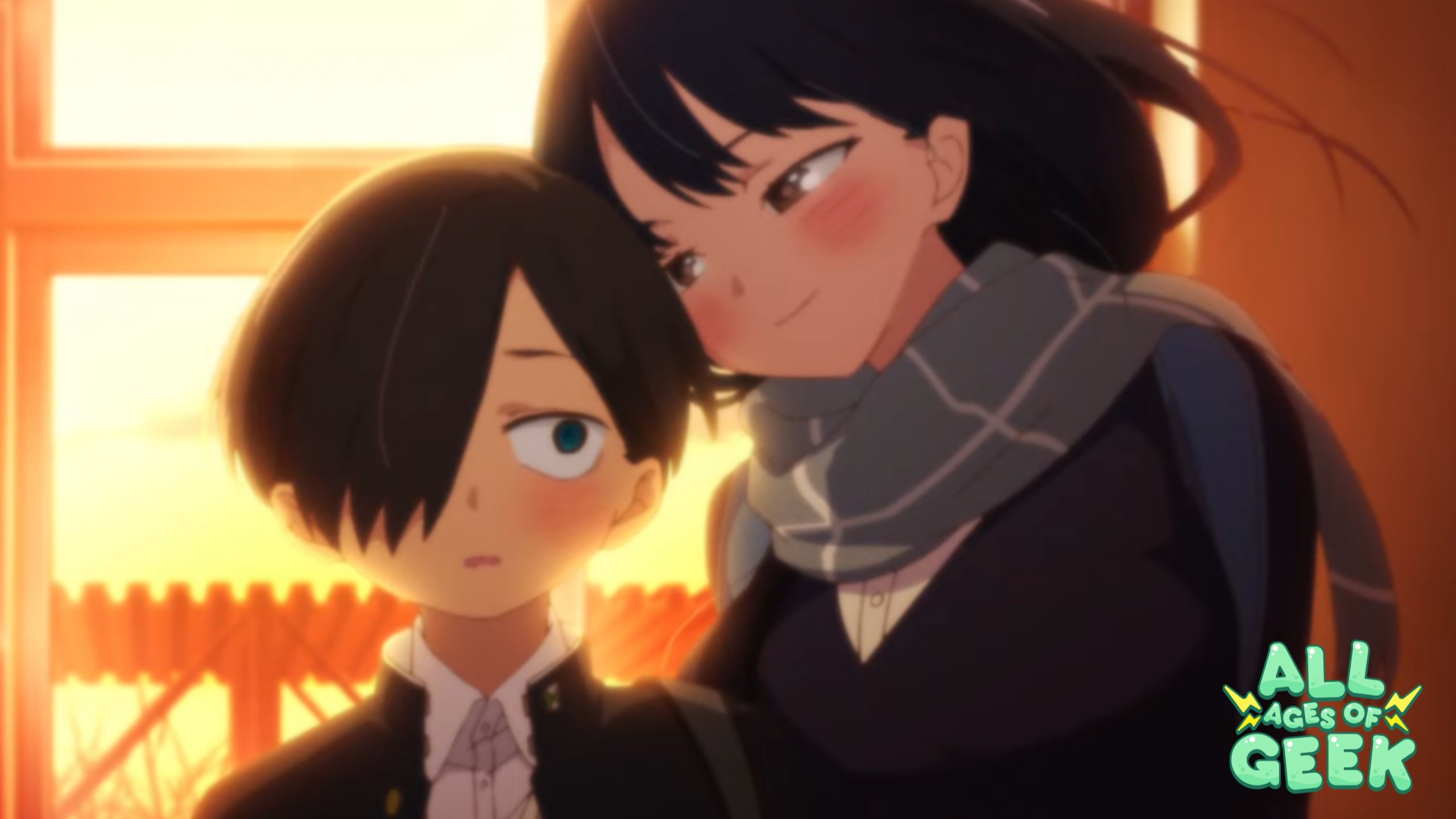 An image from the anime "The Dangers in My Heart Season 2," featuring two characters during a tender moment. The scene captures a boy in a school uniform with a surprised expression as a smiling girl with black hair hugs him from behind. Both are highlighted against the warm glow of a setting sun that filters through a window, adding to the gentle atmosphere of the scene. The "ALL AGES OF GEEK" logo is prominently displayed in the lower right corner, suggesting this is promotional content for the series associated with their brand.