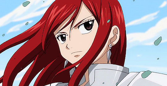 Erza Scarlet from Fairy Tail, with a serious expression and long red hair flowing in the wind, wearing white armor, set against a blue sky with scattered clouds.