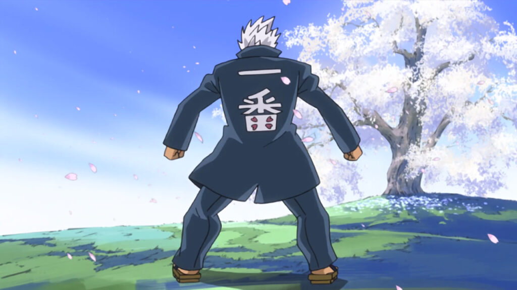 Elfman standing with his arms spread outward, in a manly position and a white blossomed tree in front of him.