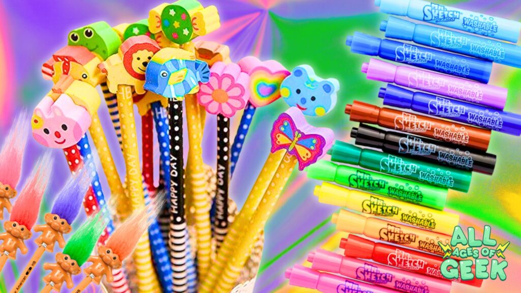 **Image Description:** The image showcases a colorful array of nostalgic 90s school supplies. On the left, there are pencils with various fun and whimsical pencil top erasers, including animals, flowers, and hearts. Below them are Troll Pencil Toppers with vibrant, fluffy hair. On the right, there is a rainbow-like display of Mr. Sketch Scented Washable Markers in various colors. The "All Ages of Geek" logo is positioned in the bottom right corner. The background features a gradient of bright, cheerful colors, enhancing the playful and nostalgic theme.