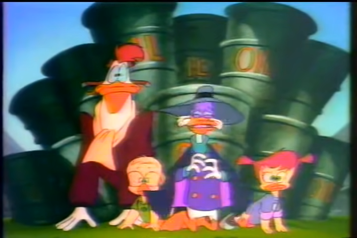 Darkwing Duck 90s scene showing a group of characters in front of oil barrels, depicting a quirky moment from the series.