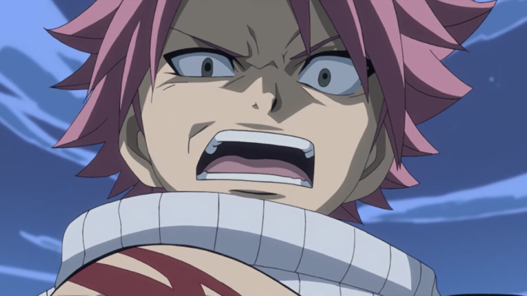 Natsu growling at an audience below, eye scrunched up and a dark shadow enveloping his upper face.