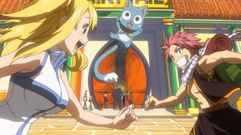 Lucy, Natsu and Happy run toward the Fairy Tail guild under a golden sunset.