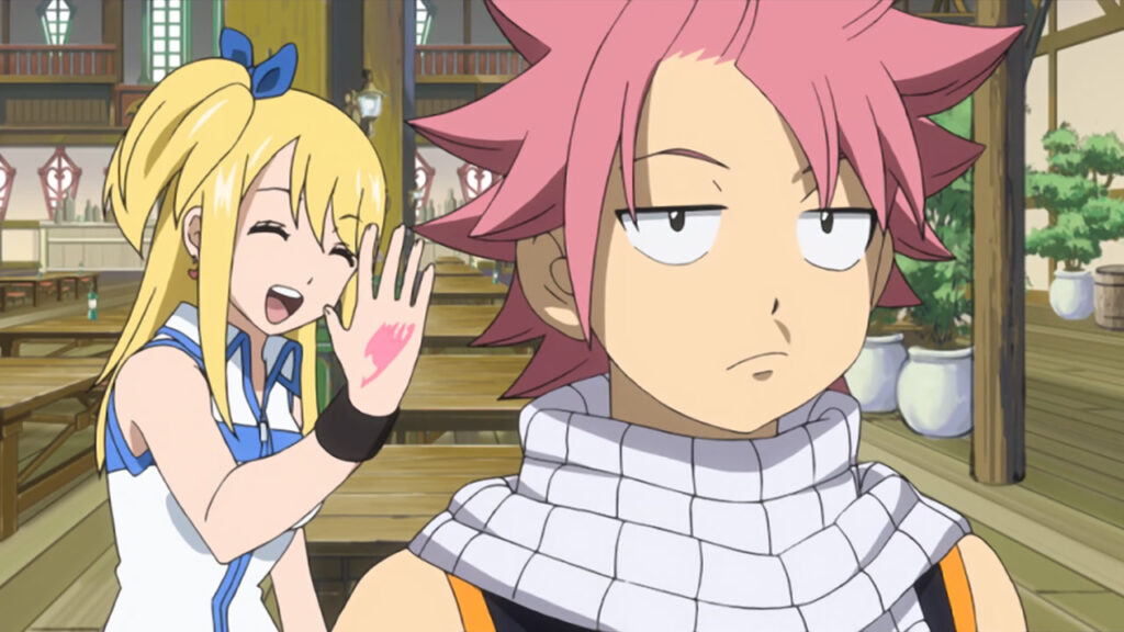 Lucy shows of off her Fairy Tail guild member tattoo while Natsu grumbles not interested in the hall's foreground.