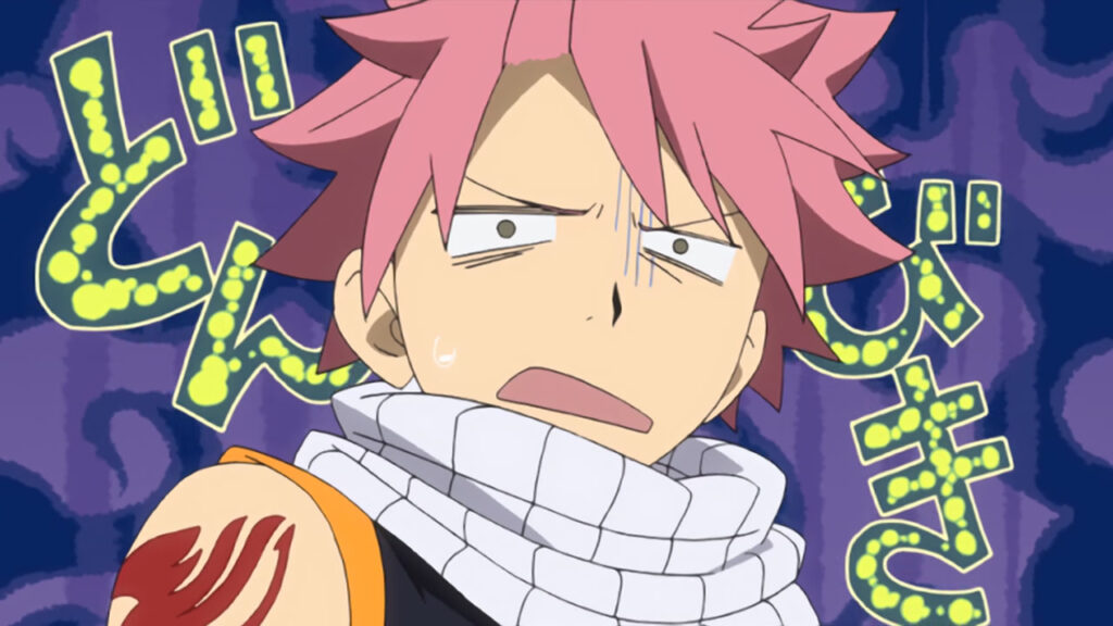 Natsu with his mouth half open and eyes annoyed and shocked stares at the camera, background a daunting purple.