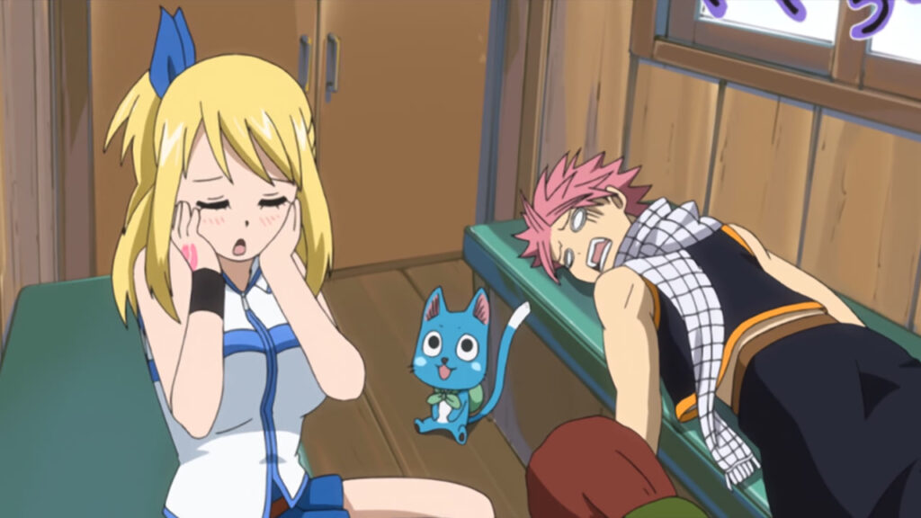 Natsu pukey and groaning sick in the background struggles to sit up, with Happy looking up at Lucy who is blushing and covering her cheeks.
