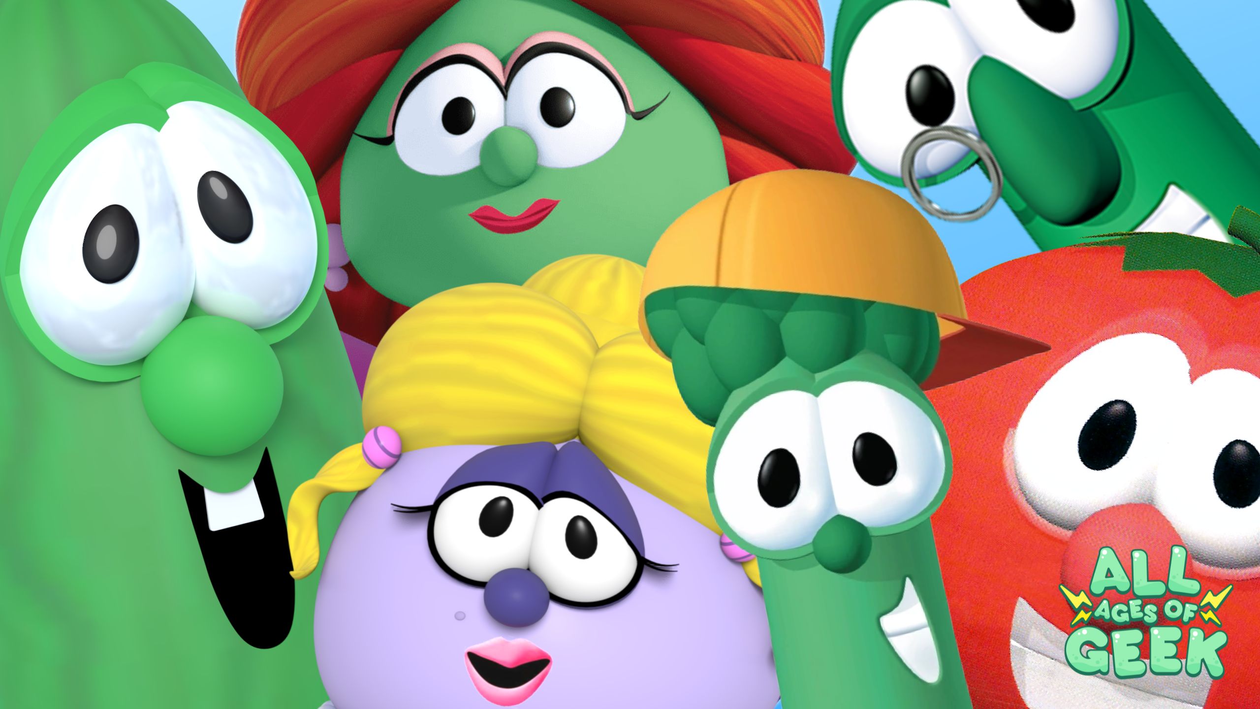 A colorful group shot of VeggieTales characters, including Bob the Tomato, Larry the Cucumber, Junior Asparagus, Madame Blueberry, and Petunia Rhubarb. They are all smiling and looking directly at the camera, set against a bright blue background. The All Ages of Geek logo is visible in the bottom right corner, adding a playful touch to the image.