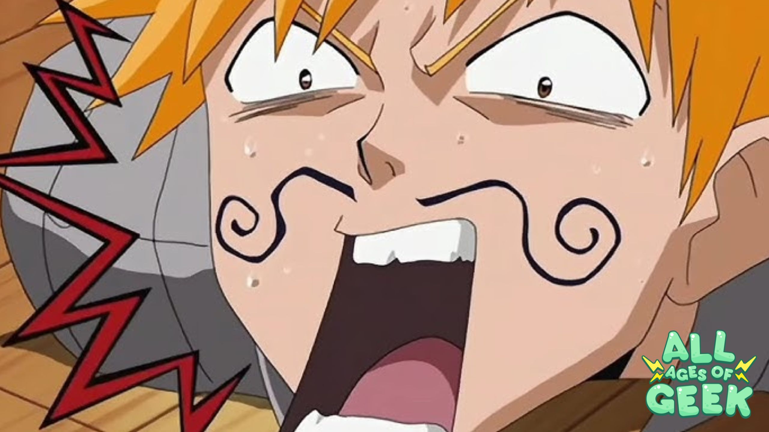 A close-up image of Ichigo Kurosaki from Bleach, displaying a comical and exaggerated expression with a swirly mustache drawn on his face. His eyes are wide open in surprise, and sweat drops are visible on his face. The All Ages of Geek logo is present in the bottom right corner.