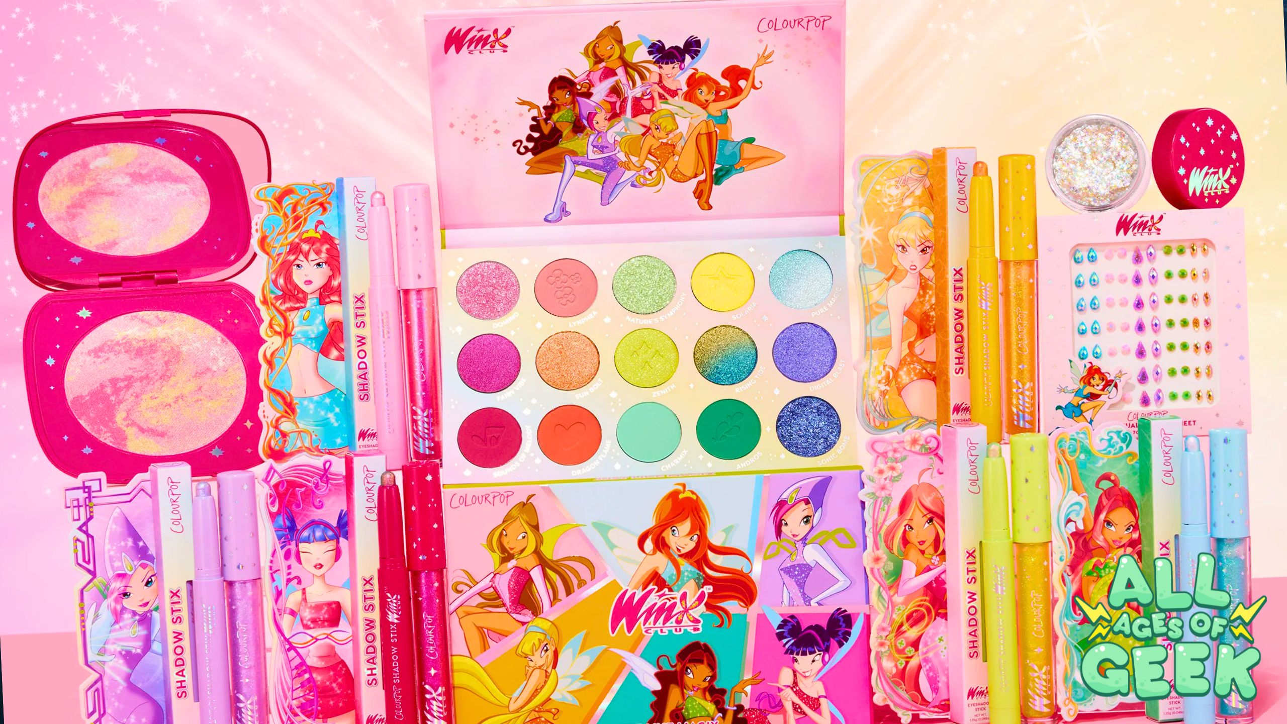 This image showcases a vibrant collection of Winx Club-themed makeup products from ColourPop. The set includes an eyeshadow palette with 15 colorful shades, shadow sticks, lip gloss, face powders, and decorative gems. Each product features illustrations of Winx Club characters, adding a whimsical and nostalgic touch. The background is a pink gradient with sparkles, enhancing the magical theme. The All Ages of Geek logo is prominently displayed in the bottom right corner.