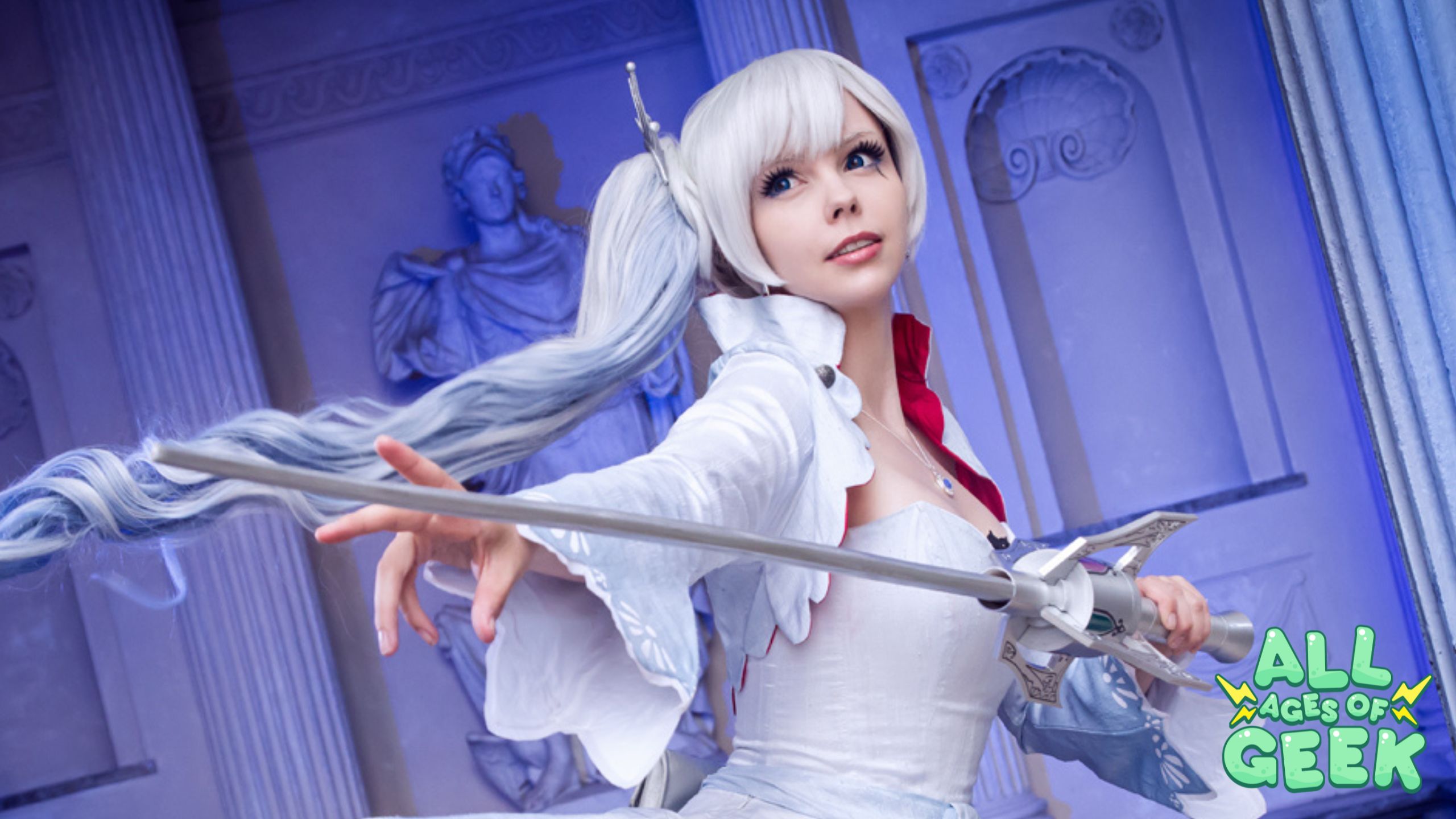 A cosplayer dressed as Weiss Schnee from RWBY, holding her rapier in a dynamic pose, set against a backdrop of classical statues and columns. The All Ages of Geek logo is visible in the bottom right corner.