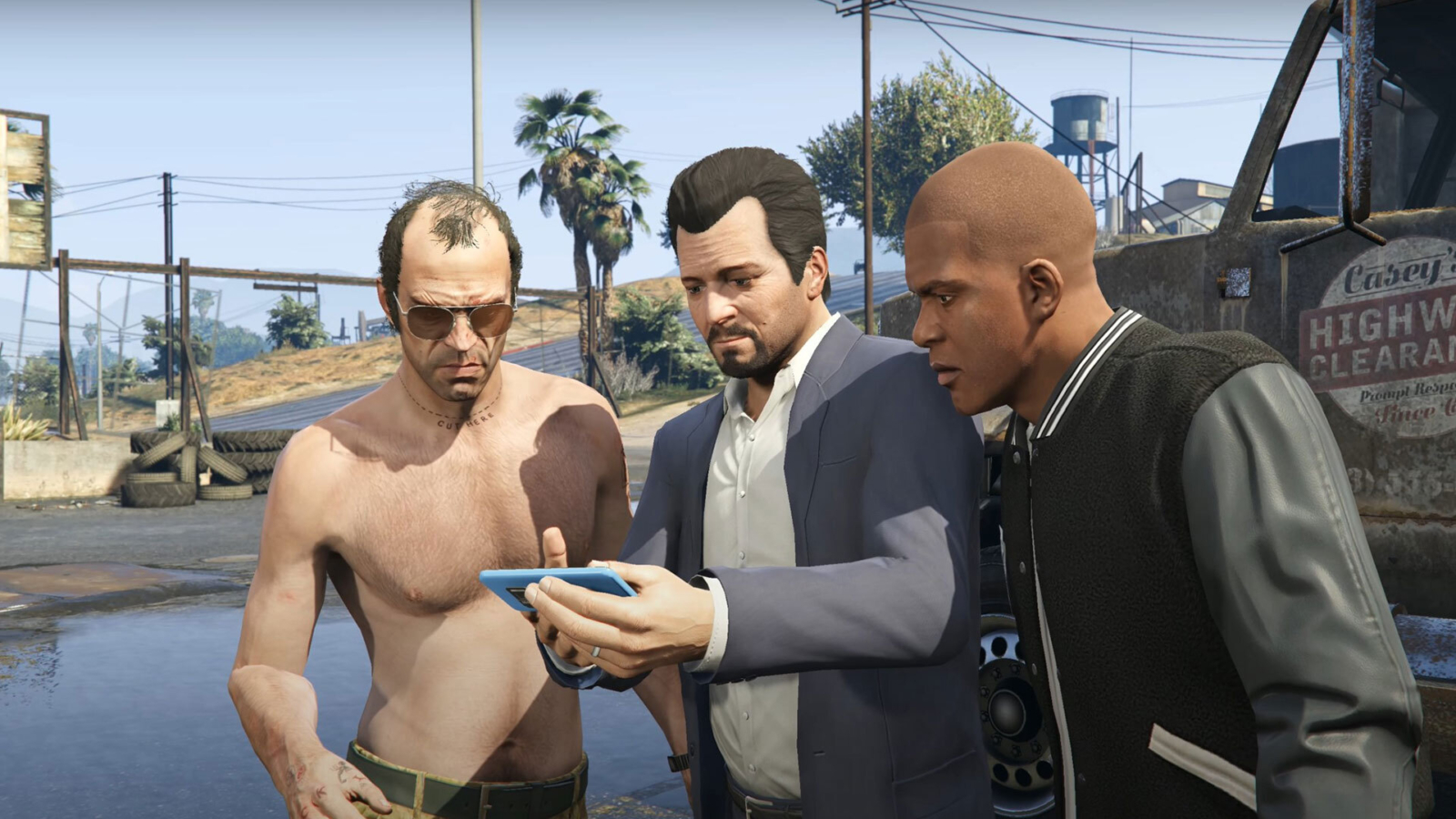 This image depicts a scene from Grand Theft Auto V featuring the game's three main protagonists—Trevor, Michael, and Franklin—gathered around looking at a phone. Trevor, shirtless and wearing sunglasses, has his typical chaotic energy, while Michael, dressed in his classic suit, appears more focused and serious. Franklin, dressed casually in a varsity jacket, leans in, clearly interested in whatever they’re examining.

The setting appears to be a rundown, industrial area, with tires and utility poles in the background, highlighting the gritty and urban environment typical of GTA V. The image encapsulates the trio's dynamic—each of them embodying distinct personalities yet working together, possibly in the middle of plotting a heist or another one of their criminal schemes. The mood is tense but focused, with all eyes on the phone, likely signaling some crucial information or mission objective.