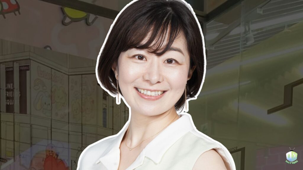 Mayuko Itagaki smiling warmly in a white outfit, with an illustrated background and the All Ages of Geek logo, promoting her interview during Tokyo Game Show 2025.