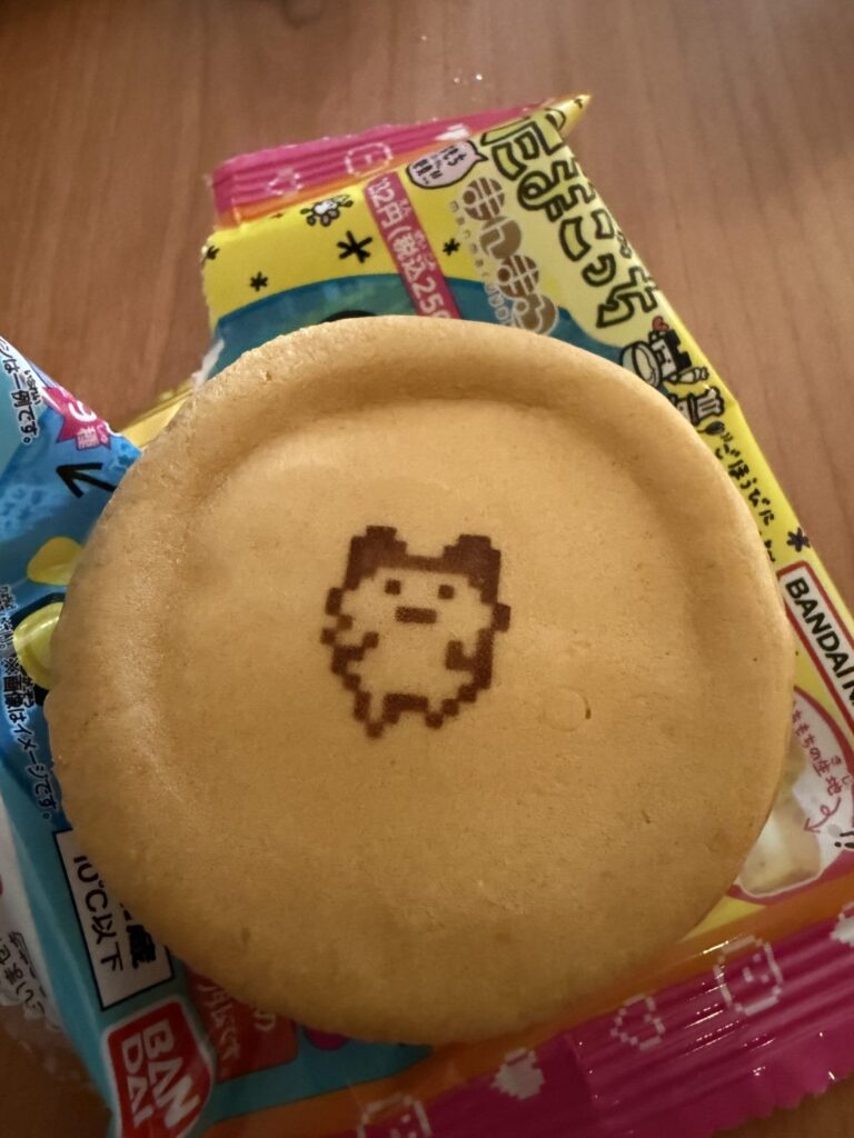 A Tamagotchi Manmaruyaki dessert featuring a cute Tamagotchi character design printed on top of the fluffy pancake-like treat.